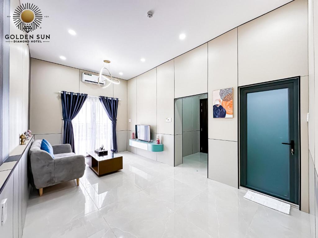 a living room with a chair and a television at Golden Sun Hotel 5 - Quận 2 in Ho Chi Minh City
