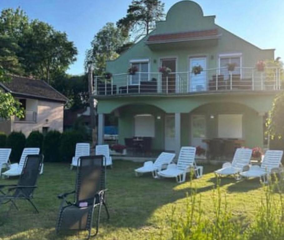 a group of chairs in the yard of a house at Vila Plaza-1 in Bela Crkva