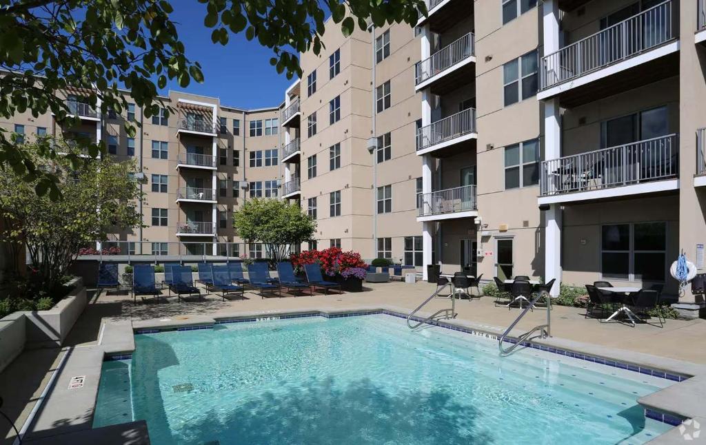 a swimming pool in the courtyard of a apartment building at TWO CozySuites at the Banks with Pool 18 in Cincinnati