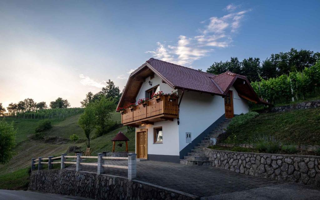 a small house with a balcony on a hill at Holiday home in Trebelno - Dolenjska & Bela krajina Unter- & Weißkrain 26032 in Trebelno