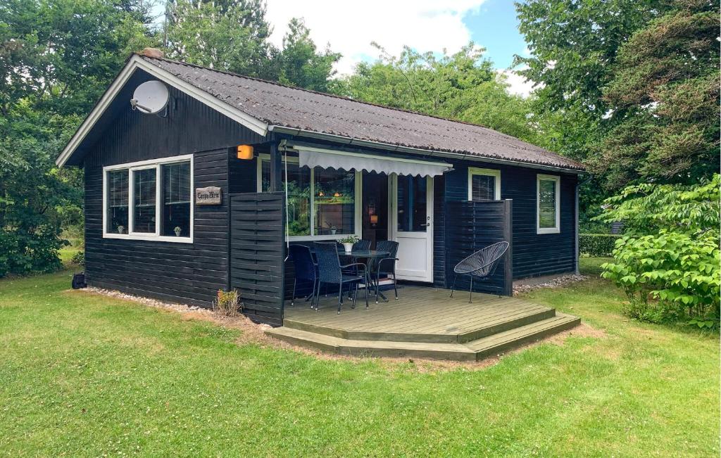 a small black shed with a deck and a table at 2 Bedroom Lovely Home In Silkeborg in Silkeborg