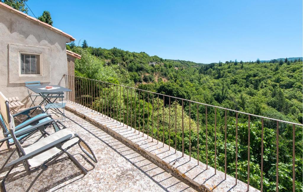 a patio with two chairs and a table on a balcony at 3 Bedroom Stunning Home In Saignon in Saignon