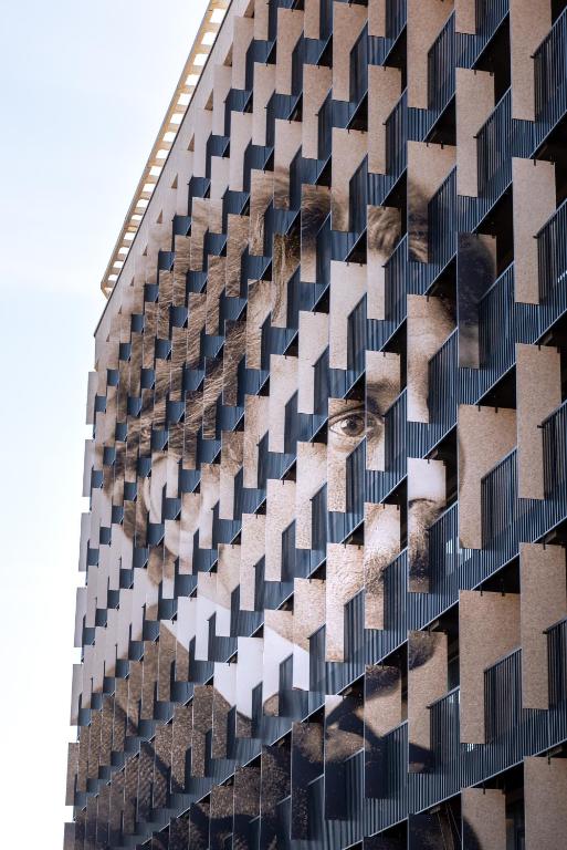a tall building with a lot of windows at Aparthotel Nemunas in Druskininkai