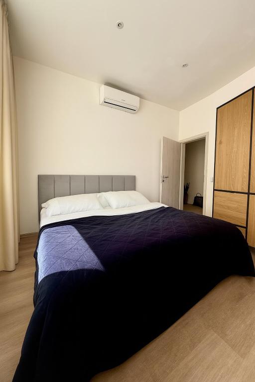 a bedroom with a large bed with purple sheets at Apartmány Hviezdoslavova in Piešťany