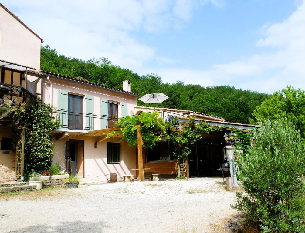 an external view of a house with trees at La Métairie de Lamourade, gîte nature in Saint-Ferriol