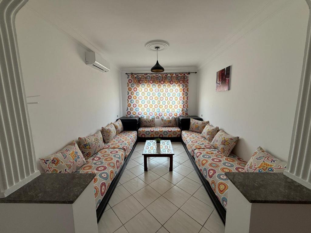 a living room with a couch and a table at Home Together Family in Tetouan