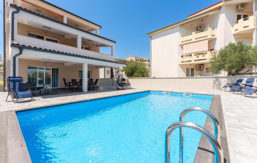 a swimming pool in front of a house at Stunning Home In Banj in Banj