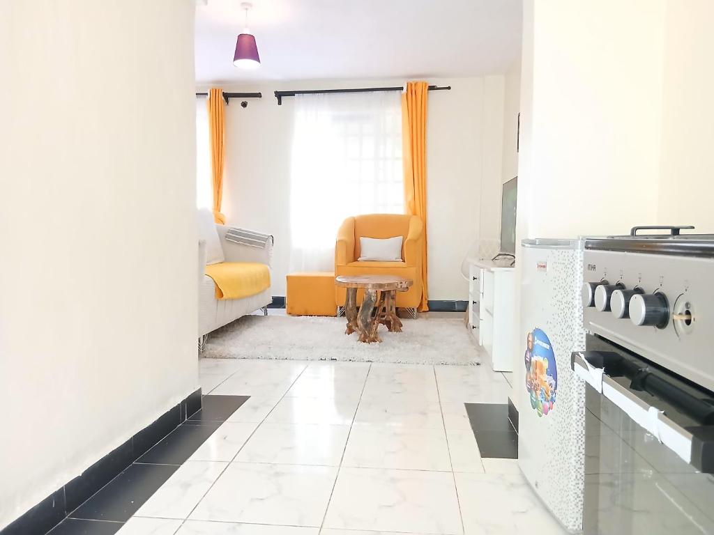 a living room with a stove and a chair at Kamemo la casa Homes in Nakuru
