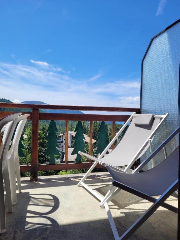 a rocking chair on a balcony with a view at Le Panorama de Valberg in Valberg