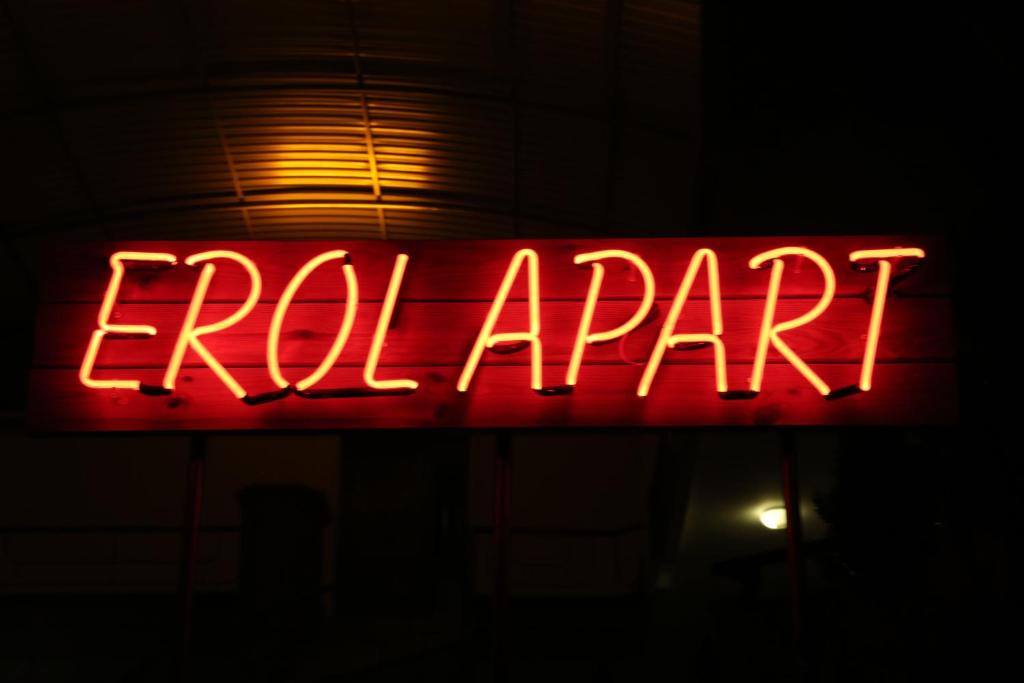 um sinal de néon vermelho que diz elefante num edifício em Erol Apart em Kemer