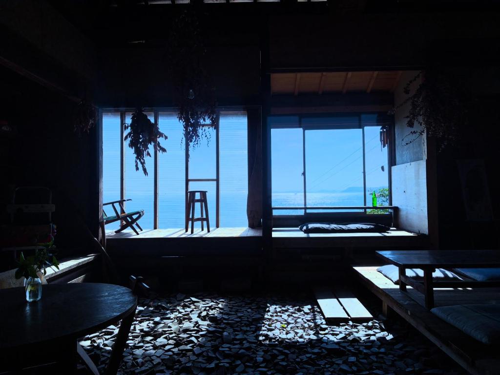 a room with tables and a view of the ocean at Lemon tree hotel in Higashiura