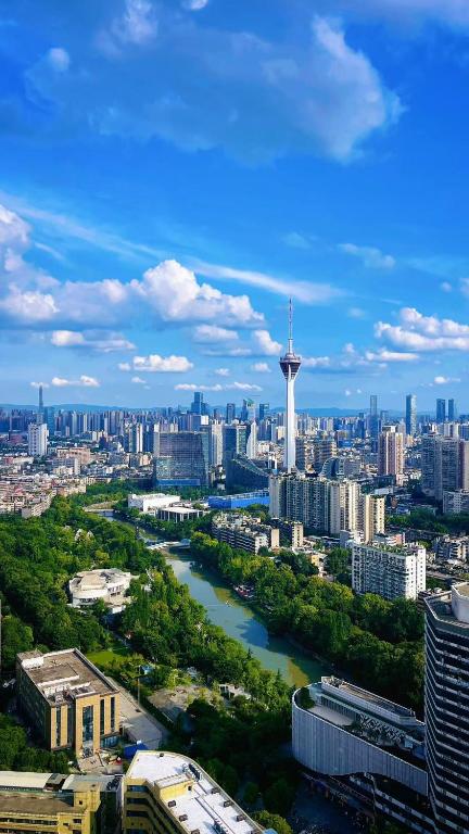 a view of a city with a river and a tower at M Panda Tower Boutique Chengdu in Chengdu