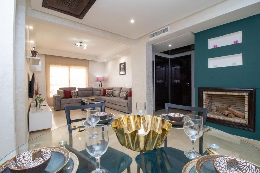 a dining room with a table and chairs and a fireplace at Mamounia Horizon in Casablanca