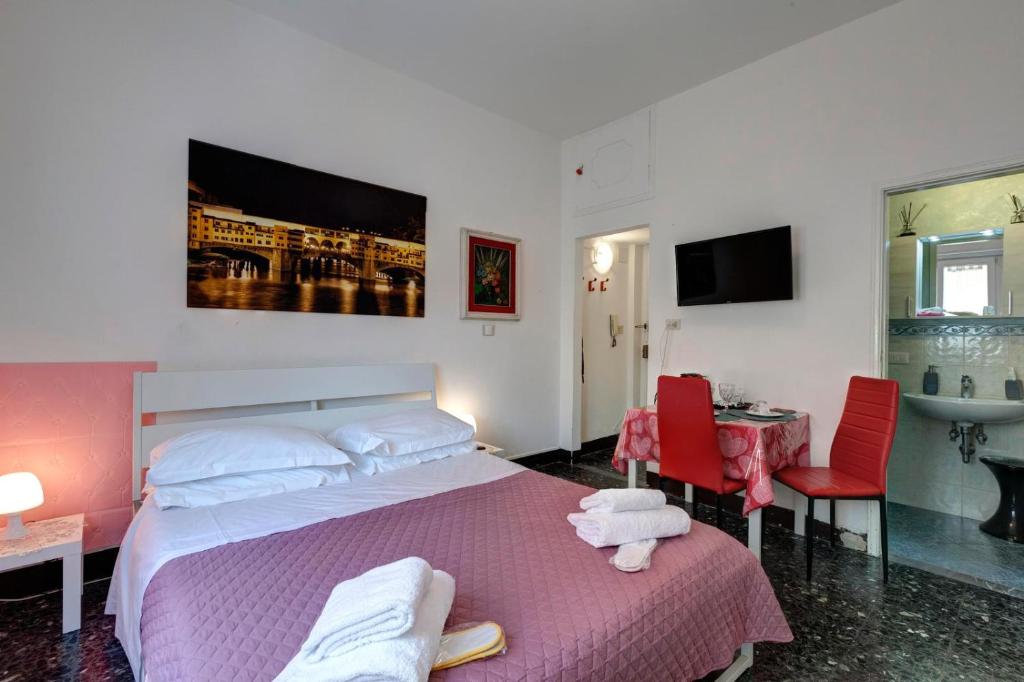 une chambre avec un lit, une table et un lavabo dans l'établissement Appartamento Lily, à Florence