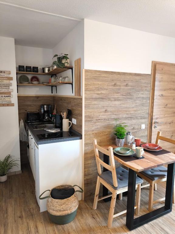 a small kitchen with a table and a stove at Ferienwohnung Claire in Bad Kohlgrub