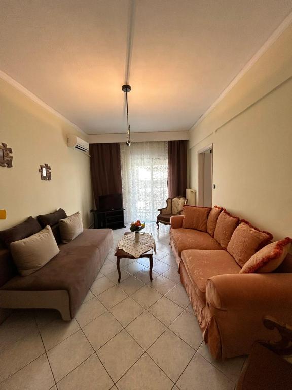 a living room with two couches and a table at Alexandroupolis Lighthouse Apartment P!!! in Alexandroupoli