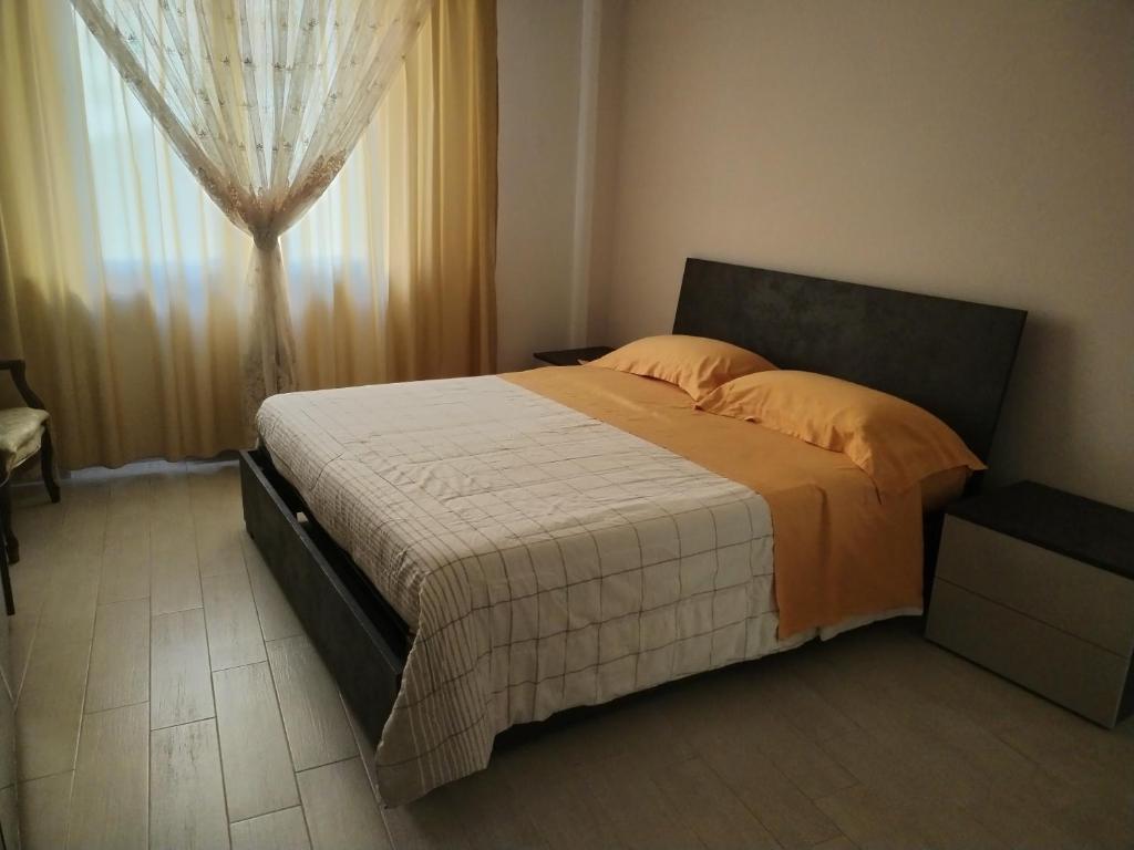 a bedroom with a large bed with a window at Casa Mari in Ancona