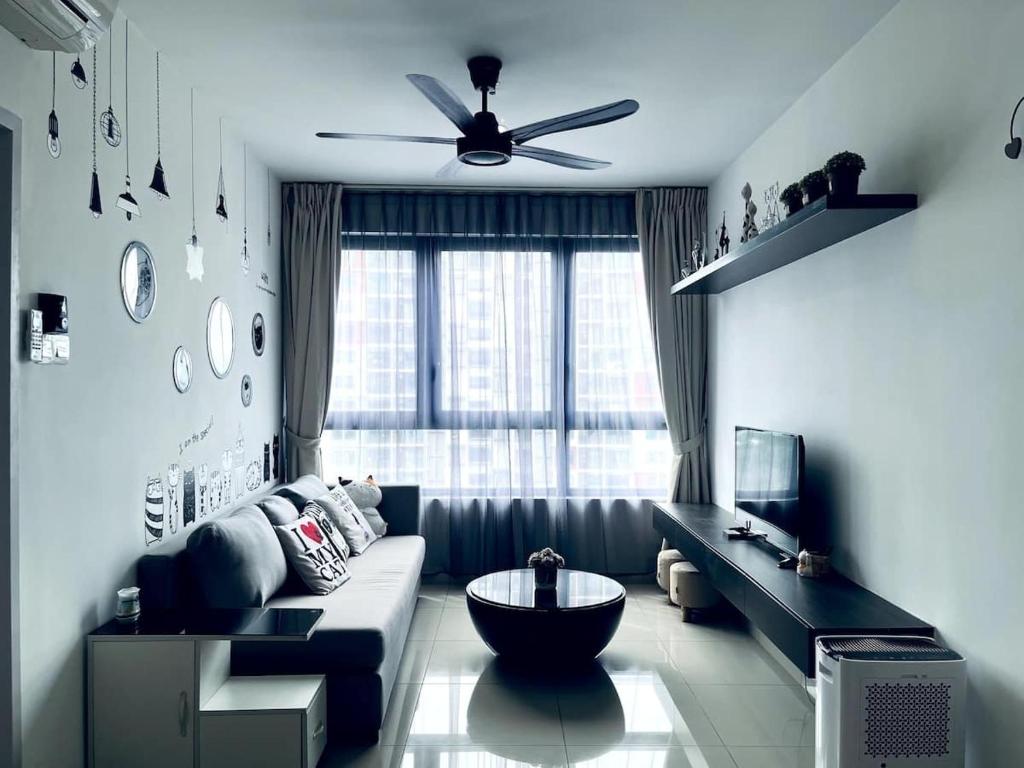 a living room with a couch and a ceiling fan at Neko Homes at i-City - WiFi TV Box 1 Carpark in Shah Alam