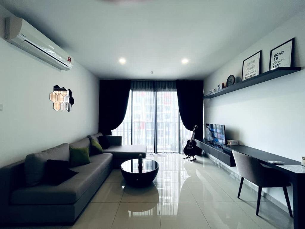 a living room with a couch and a table at Novel Homes at i-City - WiFi TV Box 1 Carpark in Shah Alam