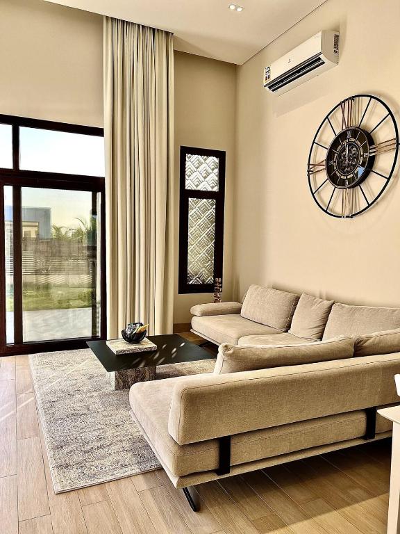 a living room with two couches and a table at WeTake Hawana in Salalah