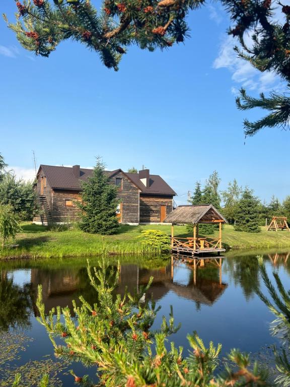 a view of the house from the lake at Cisarska sadyba in Svityazʼ