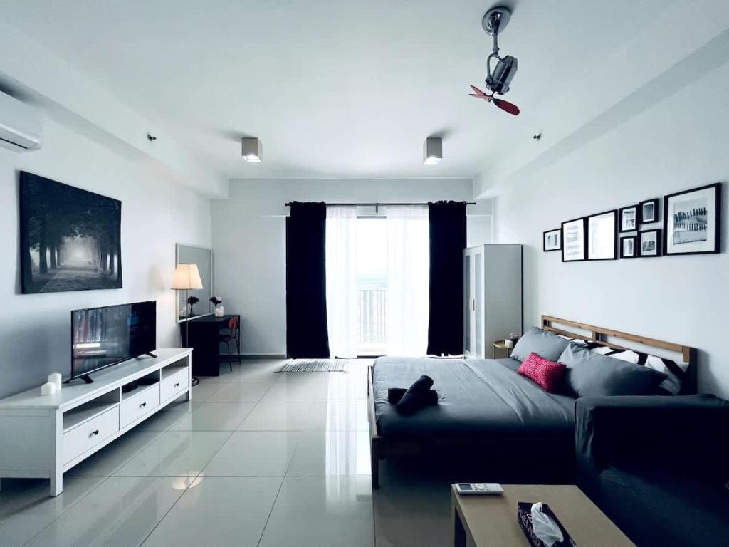 a living room with a bed and a tv at Oasis Homes at i-City - WiFi TV Box and 1 Carpark in Shah Alam