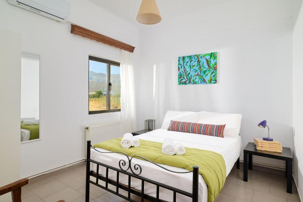 a bedroom with a bed with two towels on it at Ephagros Cretan Countryside House in Dionisi in Dyonisio