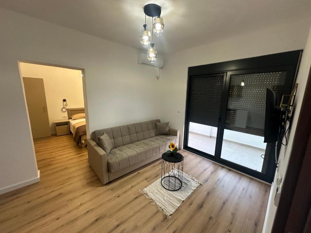 a living room with a couch and a table at Vhtwins apartment in Ulcinj