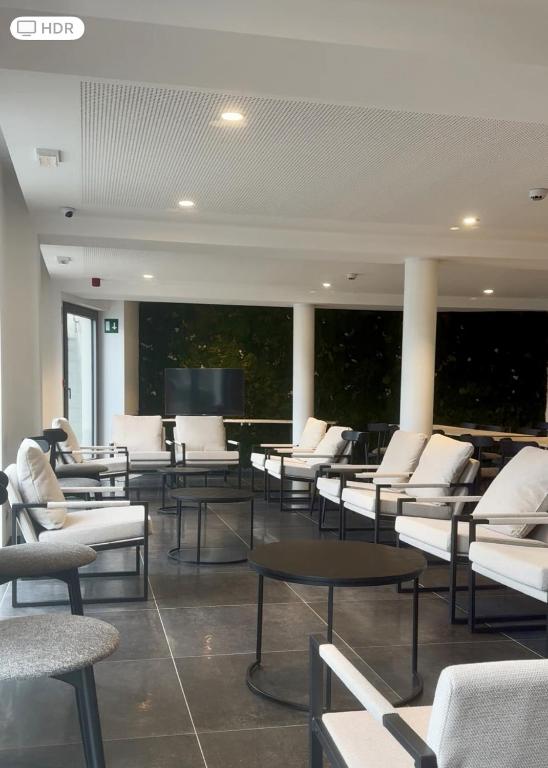 a room with chairs and tables and a flat screen tv at MAISON de VACANCES Bouillon 30 personnes in Bouillon