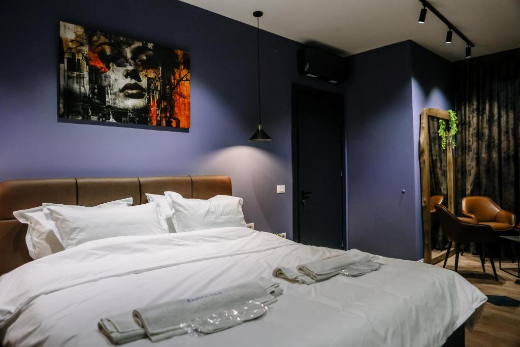 a bedroom with a large white bed with white pillows at Karma Chic&Style Appartamento 1 in Korçë