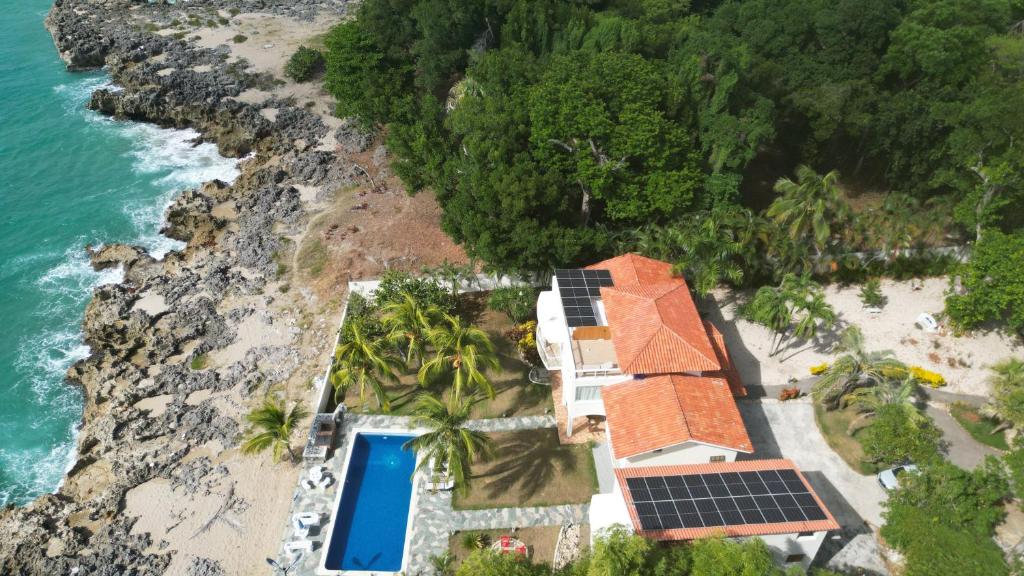 an aerial view of a house with solar panels on the beach at Crimson beach ocean front entire floor villa in Sosúa