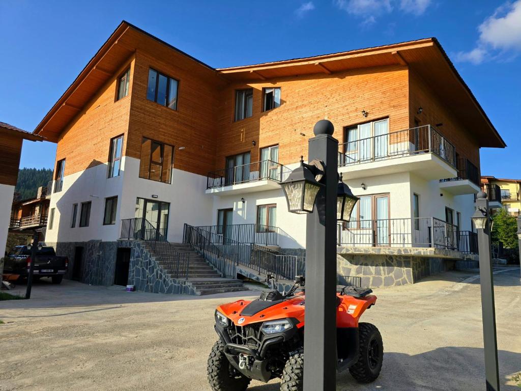 an orange atv parked in front of a building at Bakuriani apartment 205 Tsakadze st 20 in Bakuriani