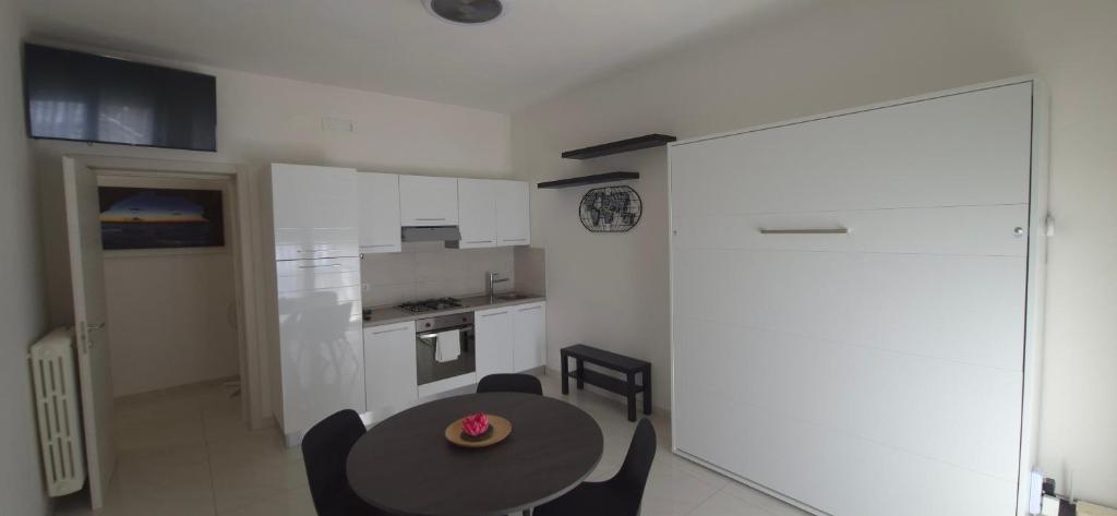 a kitchen with a table and chairs in a room at La Dimora di Maja in Pescara