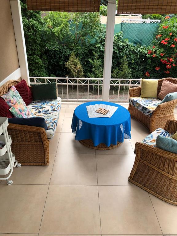 a patio with a blue table and chairs at Apartment Patricia in Siófok