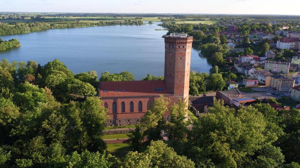 an aerial view of a building next to a lake at 120m2 APARTAMENT LAS I JEZIORO in Człuchów