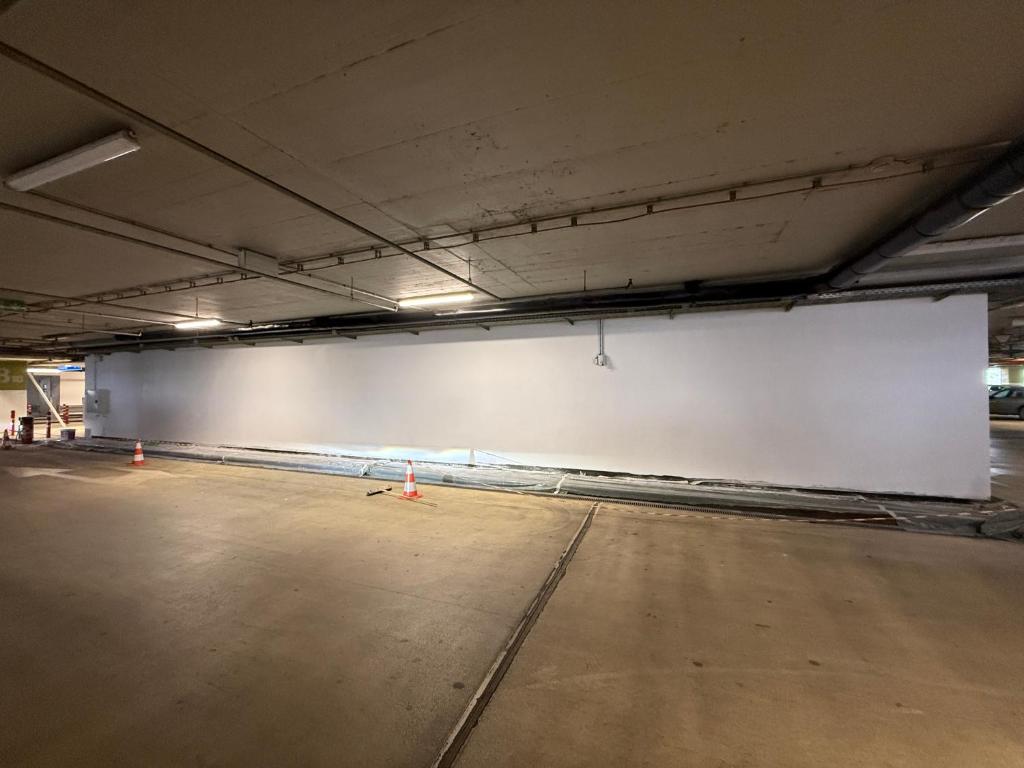 an empty parking garage with a large white wall at Demo apartment 1 in Sofia