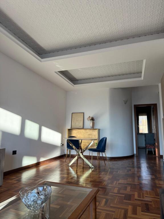 an empty living room with a table and chairs at Luxury flat on the heart of Reggio Calabria in Reggio Calabria