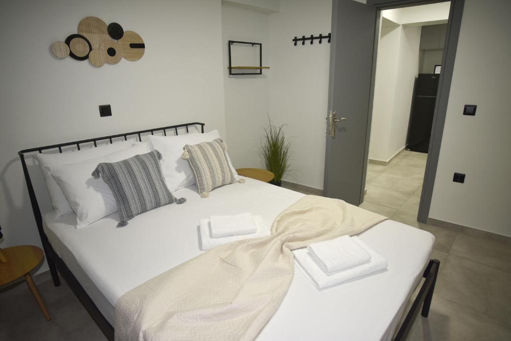 a bedroom with a white bed with two pillows at Paul's Houses 2 in Drama