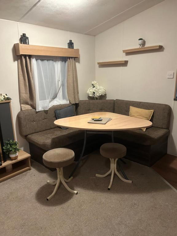 a couch and a table in a living room at 2 bed caravan seawick hoilday Park in Clacton-on-Sea