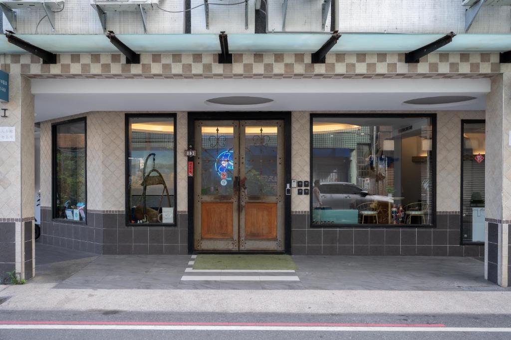 a store front with a wooden door and glass windows at 日日藍旅市區民宿 in Hualien City