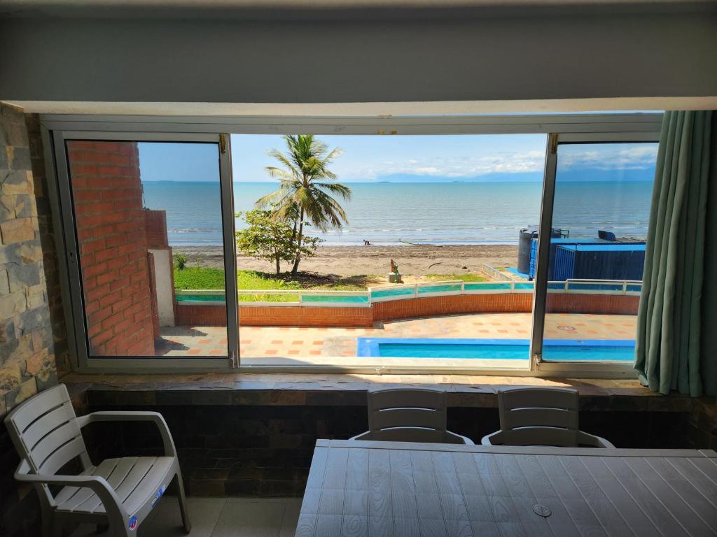 a room with a view of the beach from a window at TUCACAS VISTA Y SALIDA AL MAR Apto TIPO ESTUDIO DUPLEX SIN HABITACIÓN INDEPENDIENTE in Tucacas