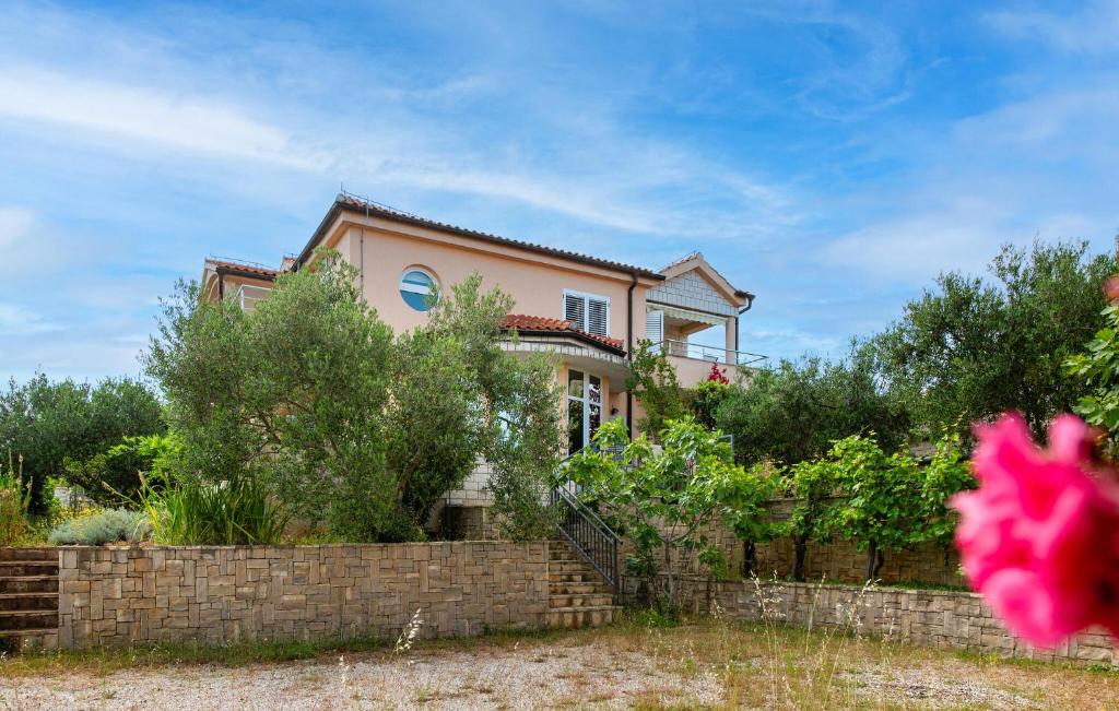 a large house with a brick fence in front of it at Gorgeous Apartment In Razanj With Wifi in Ražanj