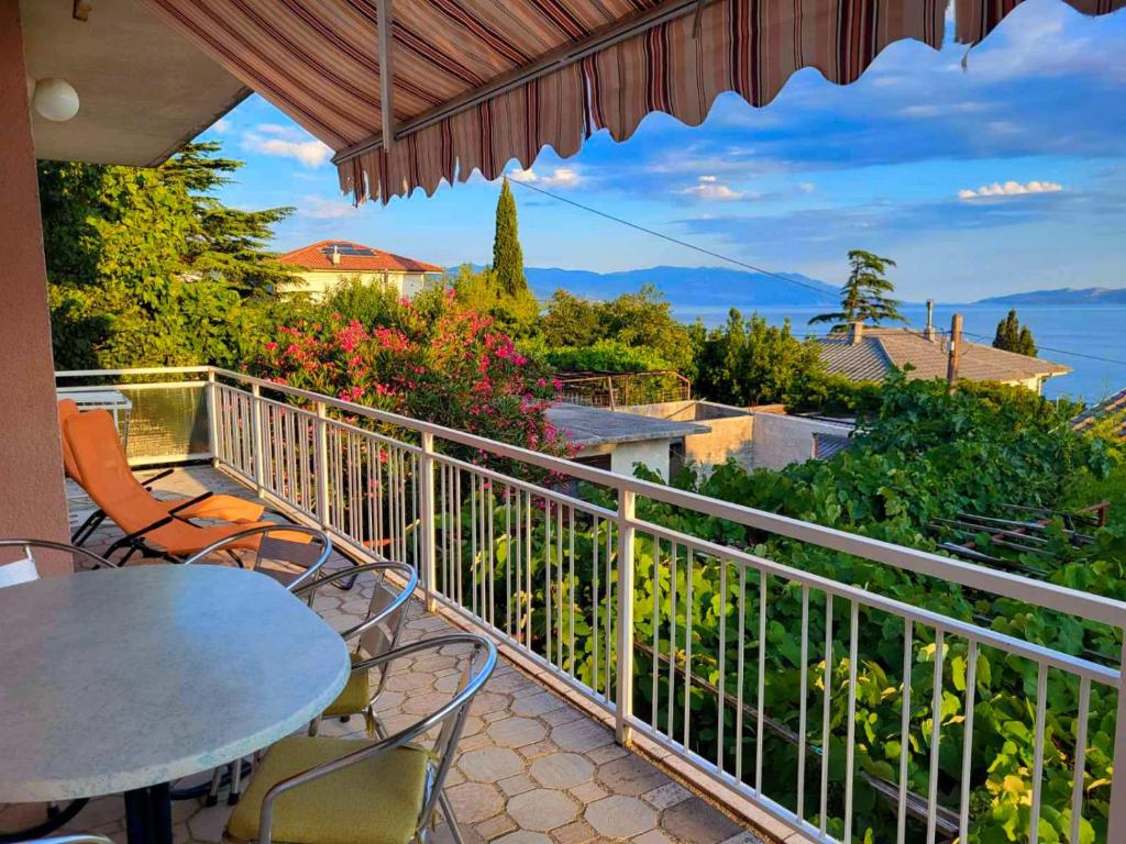 a balcony with a table and chairs and a view at Apartmens Adriana in Novi Vinodolski