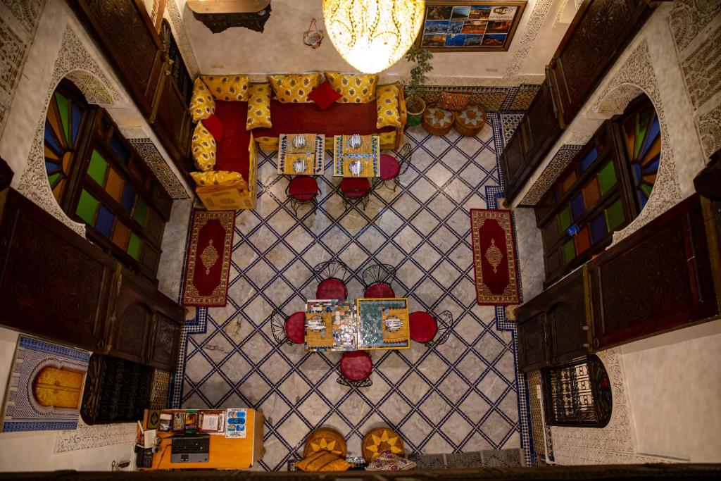 an overhead view of a ceiling with stained glass at Riad LalaMoune in Fez