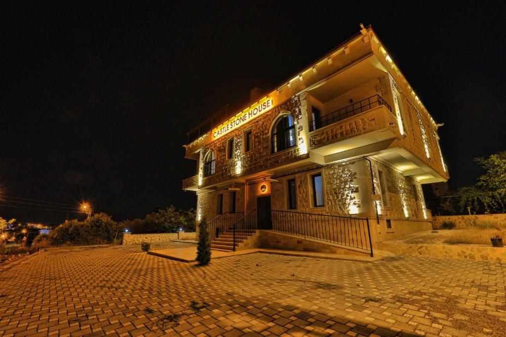 a building with lights on it at night at Castle Stone House in Uçhisar