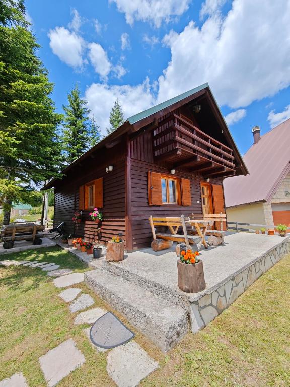a log cabin with a pathway leading up to it at Holiday Home Bella in Žabljak