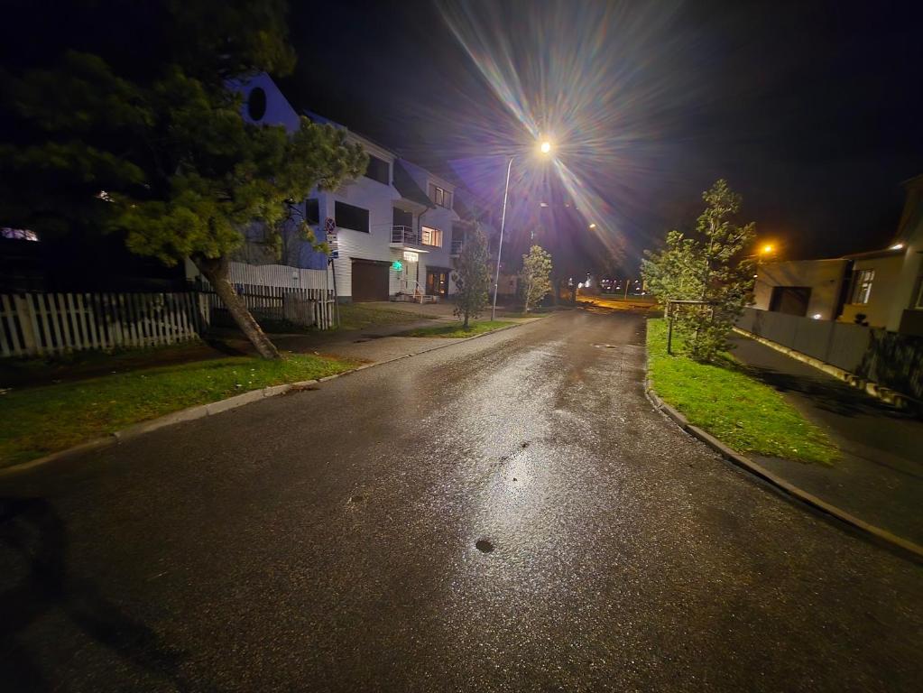 an empty street at night with a street light at Ranna Resort Hostel in Pärnu