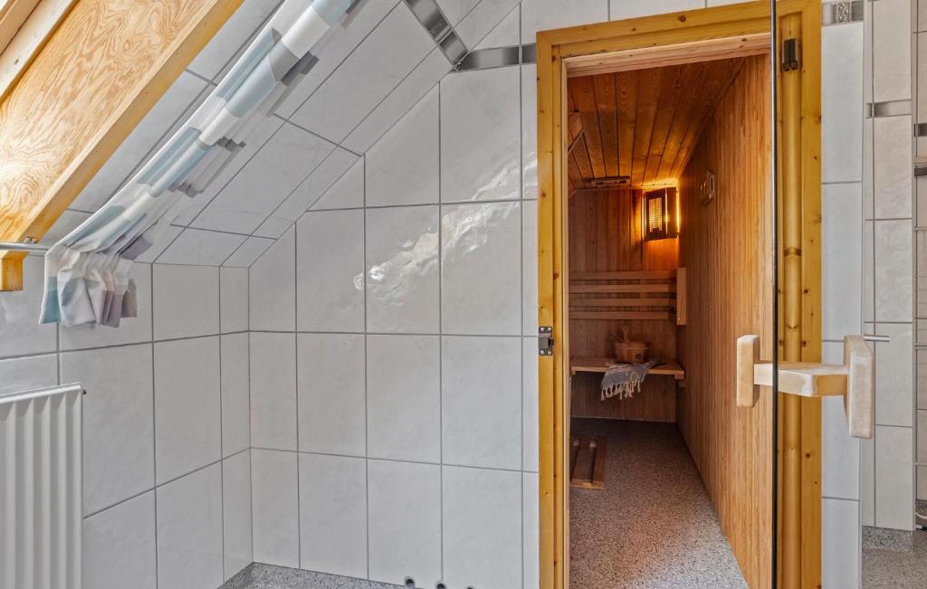 a bathroom with a shower with white tiles at 3 Bedroom Gorgeous Apartment In Højer in Højer