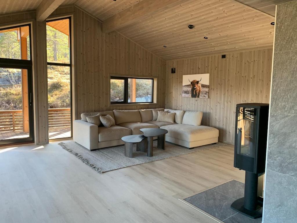 a living room with a couch and a tv at Moderne og romslig familiehytte i Stryn in Stryn