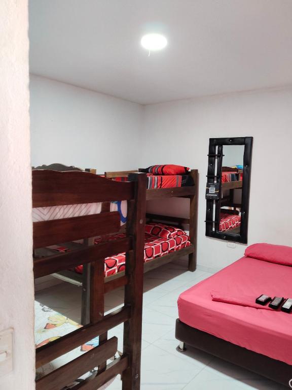 a room with two bunk beds and a mirror at LA MEDELLIN HOSTAL in Cartagena de Indias